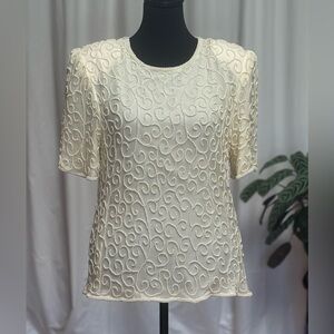 Beaded top in ivory. Pearl scroll pattern on sheer fabric. Fully lined in silk.